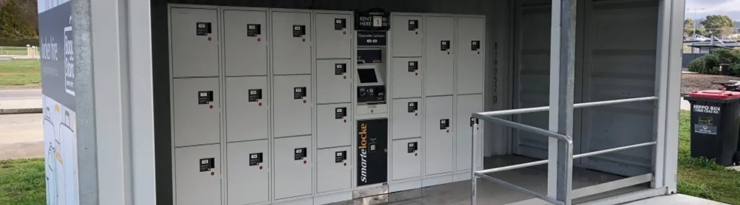 Shipping container modified into a locker facility, with individual locker doors visible along the container’s interior walls.