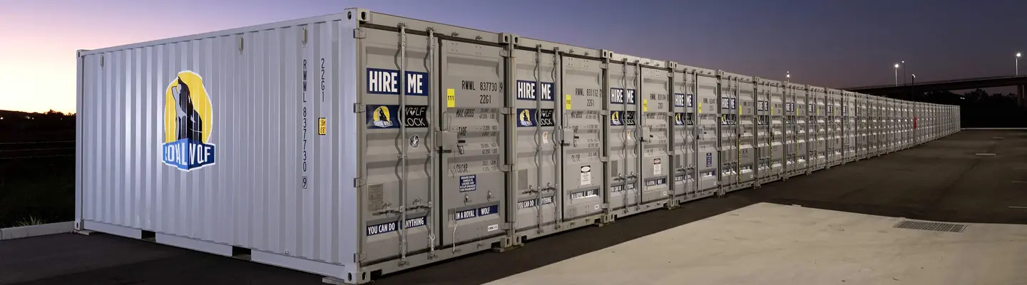 Stacked storage containers at an industrial site, illustrating large-scale storage, shipping, or construction operations.
