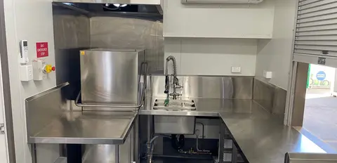Commercial Kitchen Equipped with Plumbing and Lighting
