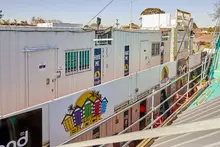 Modified storage containers as barriers on a film set, ensuring safety and site organisation